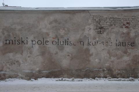 Grafiti hallil seinal musta värvi tekstiga "Miski pole olulisem kui see lause".